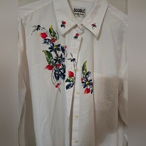 Ladies button up shirt with decoration on front and back.